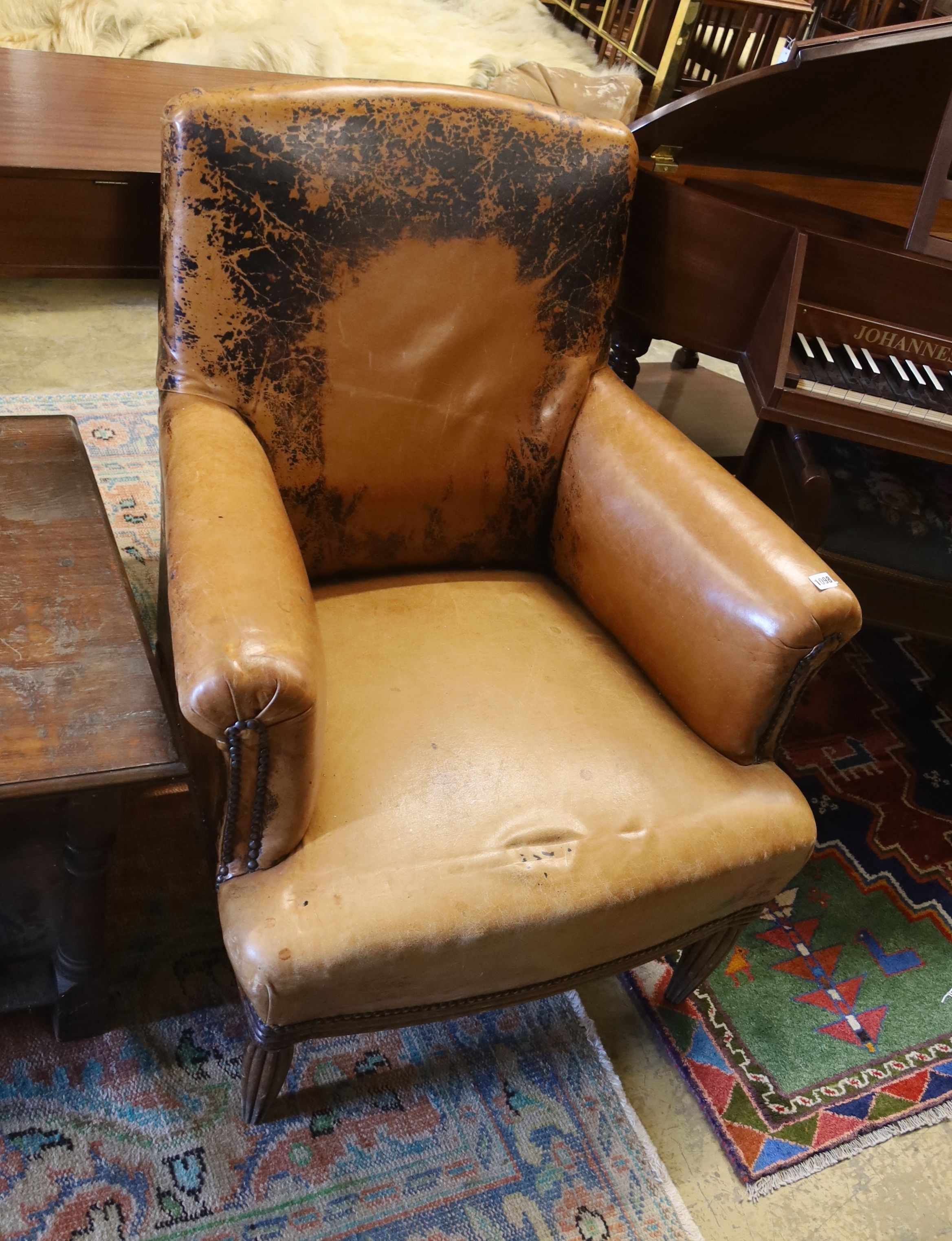 An early 20th century French tan leather club chair, width 78cm, depth 66cm, height 88cm